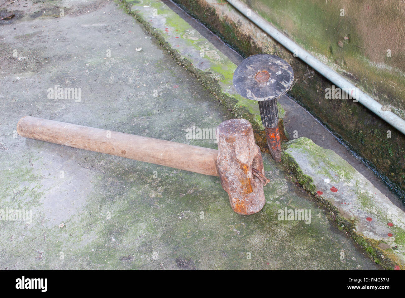 Dig or drill a hole in the cement wall using cold chisels and hammer