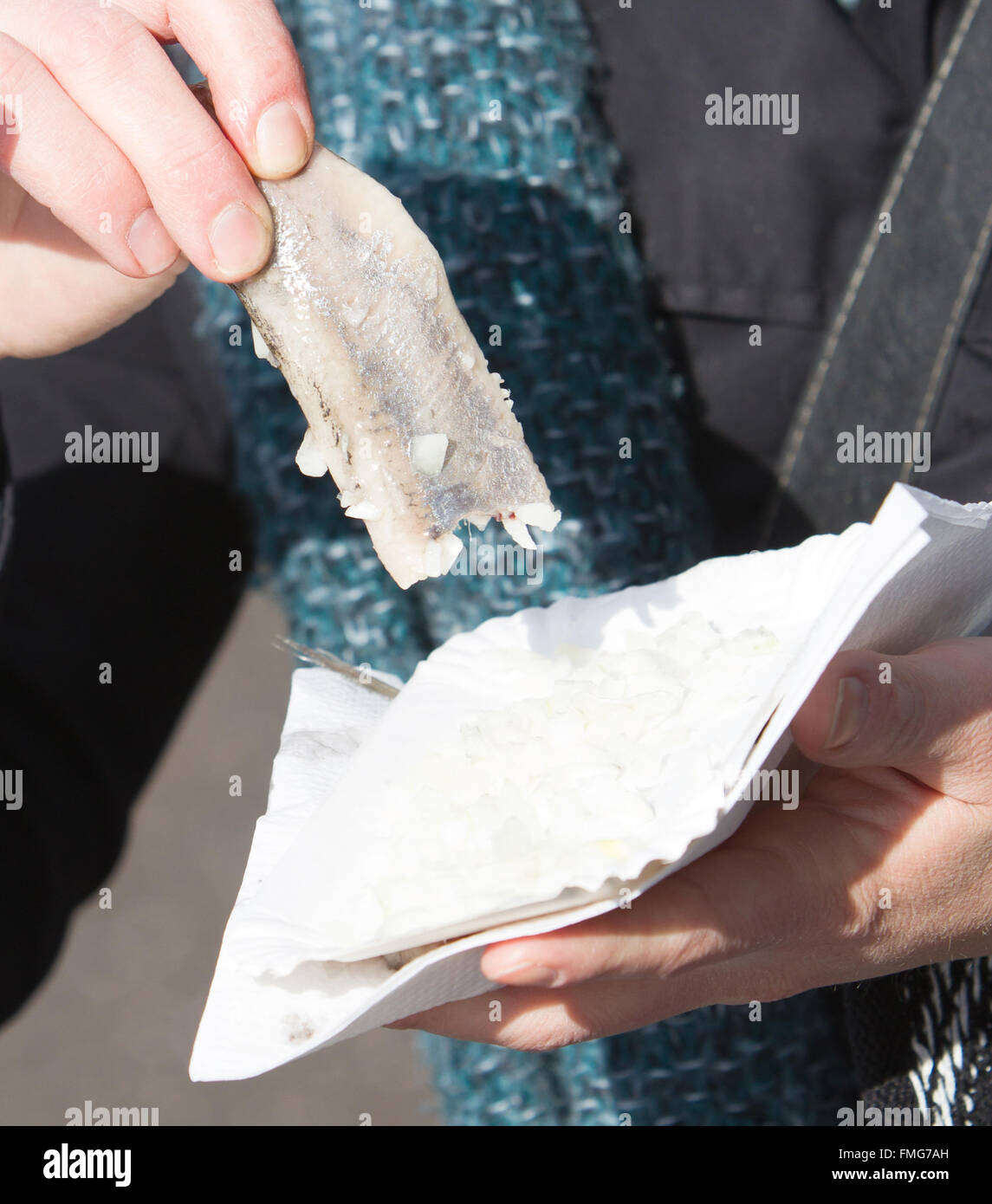 Dutch woman is eating typical raw herring with onions Stock Photo Alamy