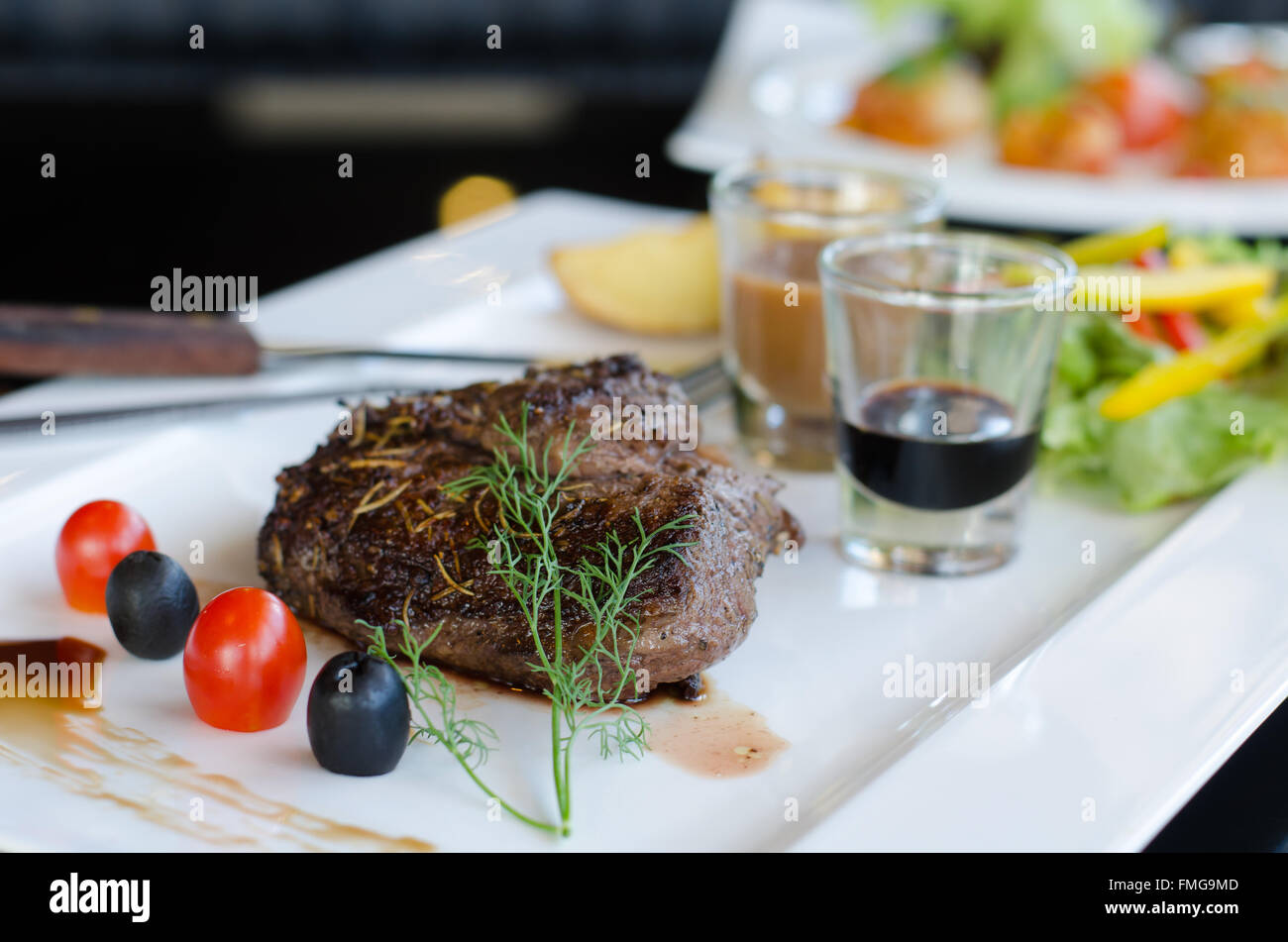 Delicious beef steaks on white plate Stock Photo