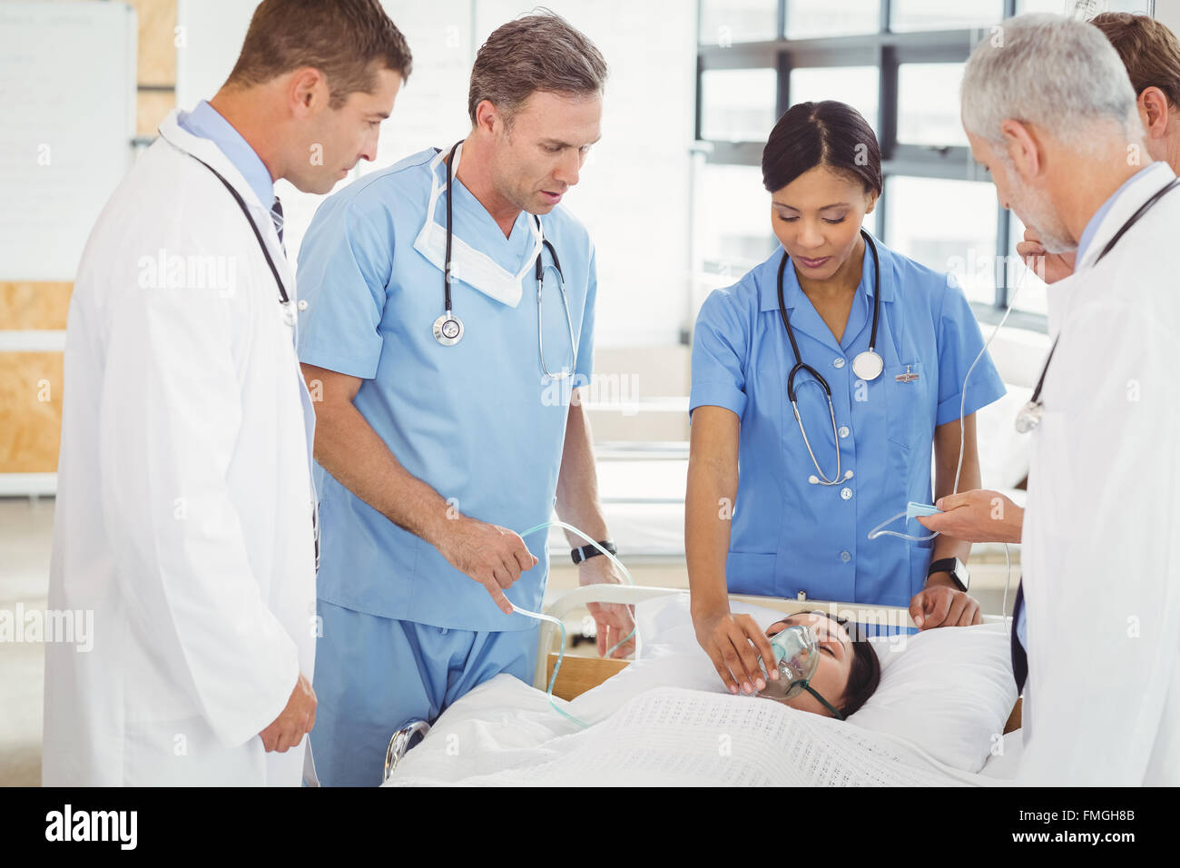Doctors putting an oxygen mask on patient Stock Photo Alamy