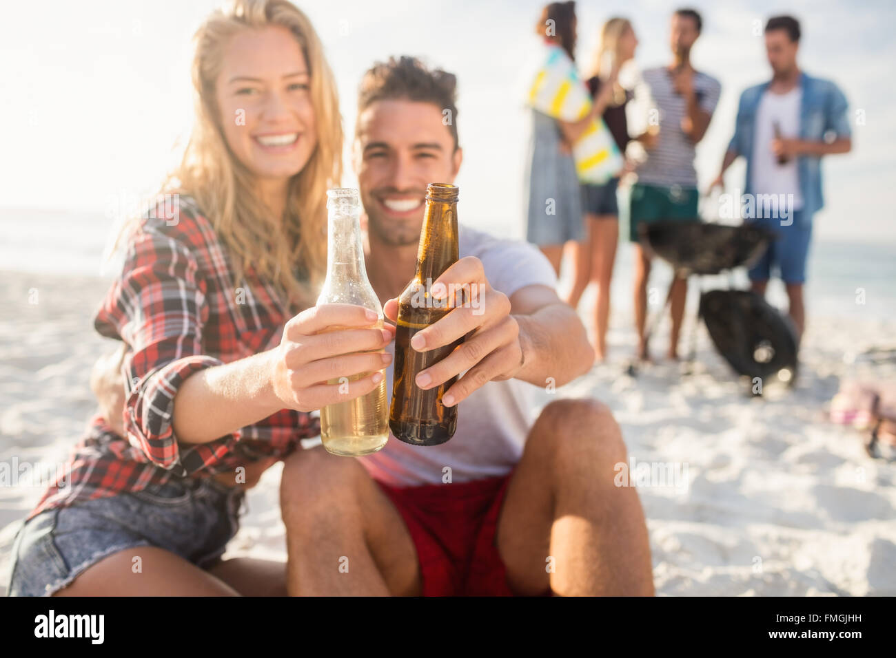 Happy friends having fun around barbecue Stock Photo - Alamy