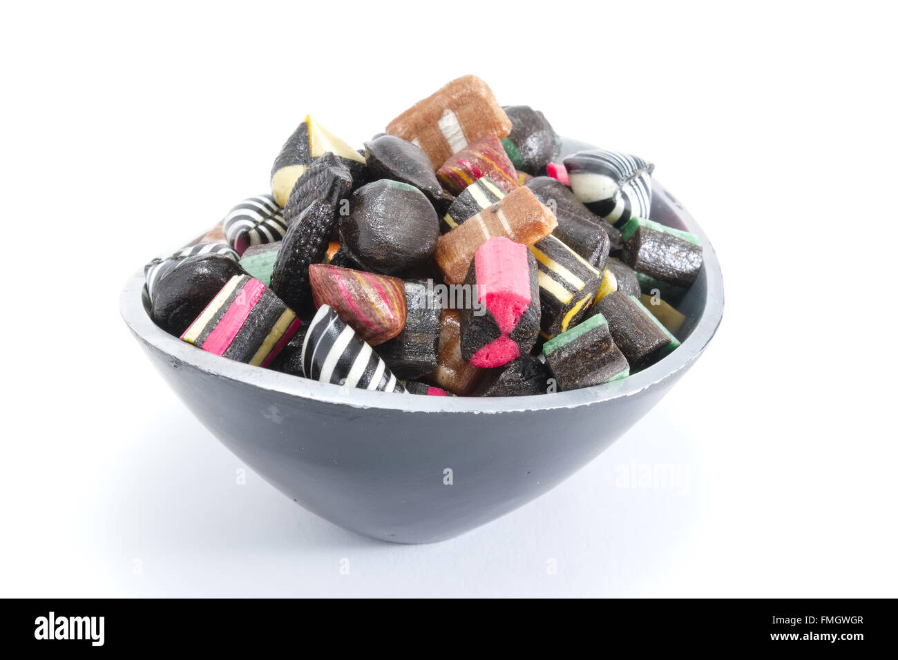 Hard candy in a bowl on a white surface Stock Photo