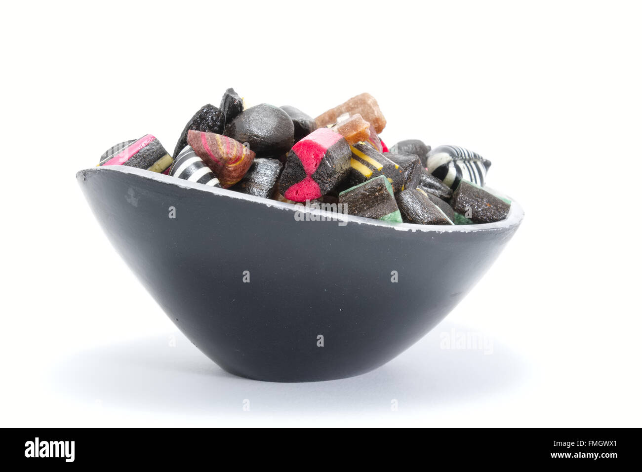 Black candy bowl filled with liquorice candy Stock Photo