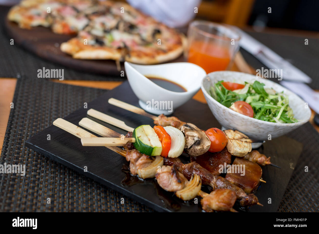 Assorted meat on skewers in  restaurant Stock Photo