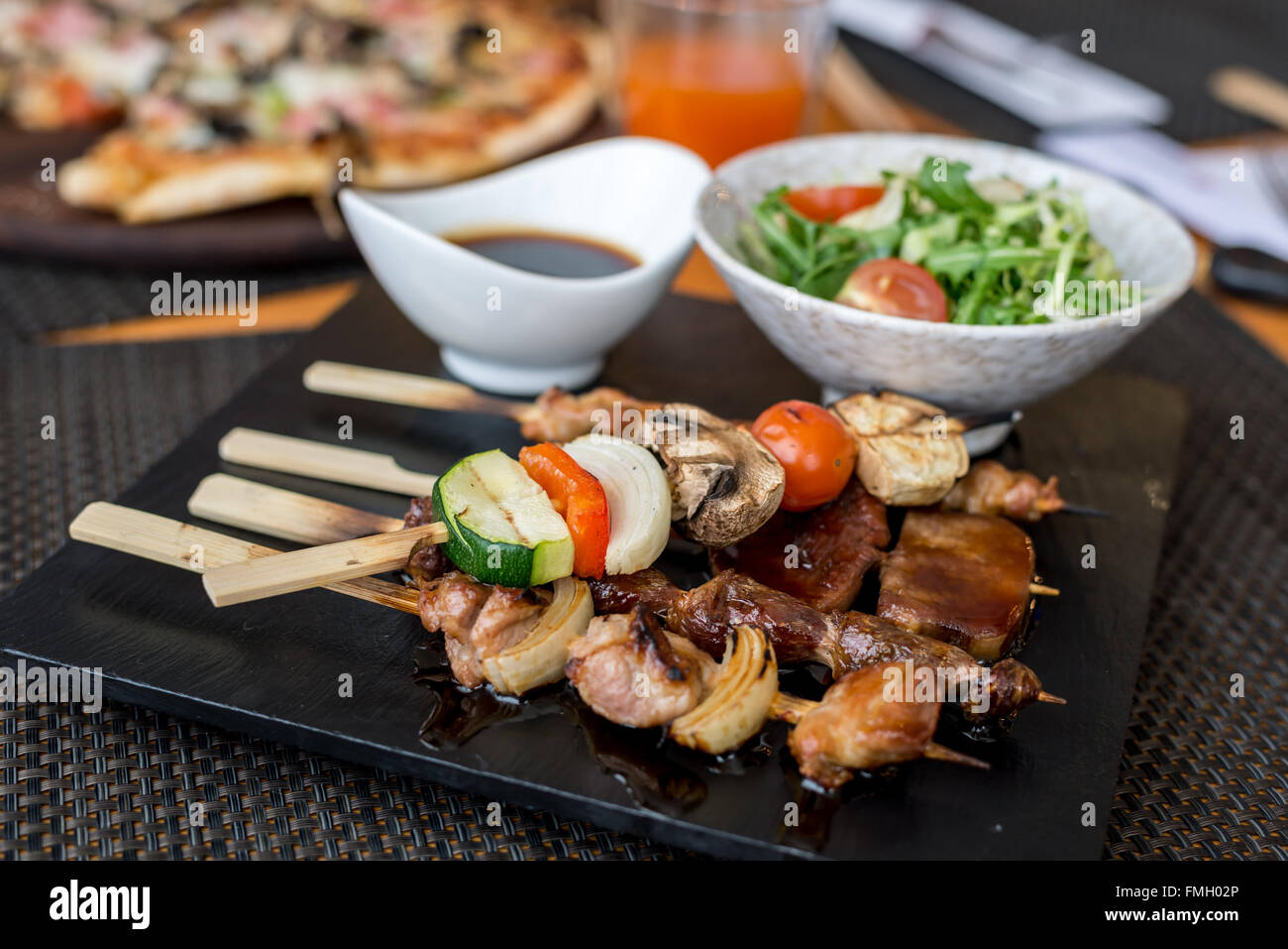 Assorted meat on skewers in  restaurant Stock Photo