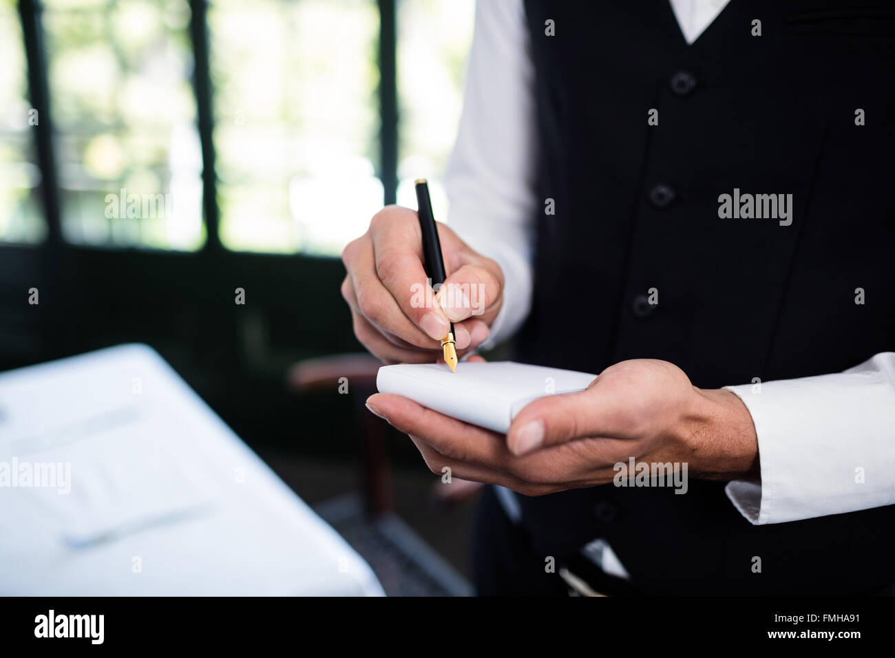 Waiter wearing uniform hi-res stock photography and images - Alamy
