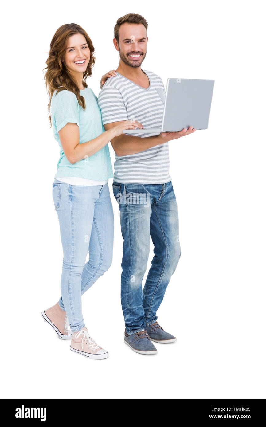 Portrait of happy young couple using laptop Stock Photo - Alamy