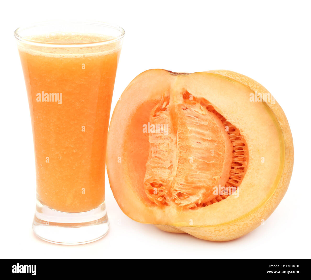 Juice of cucumis melo or muskmelon in a glass with sliced fruit Stock Photo