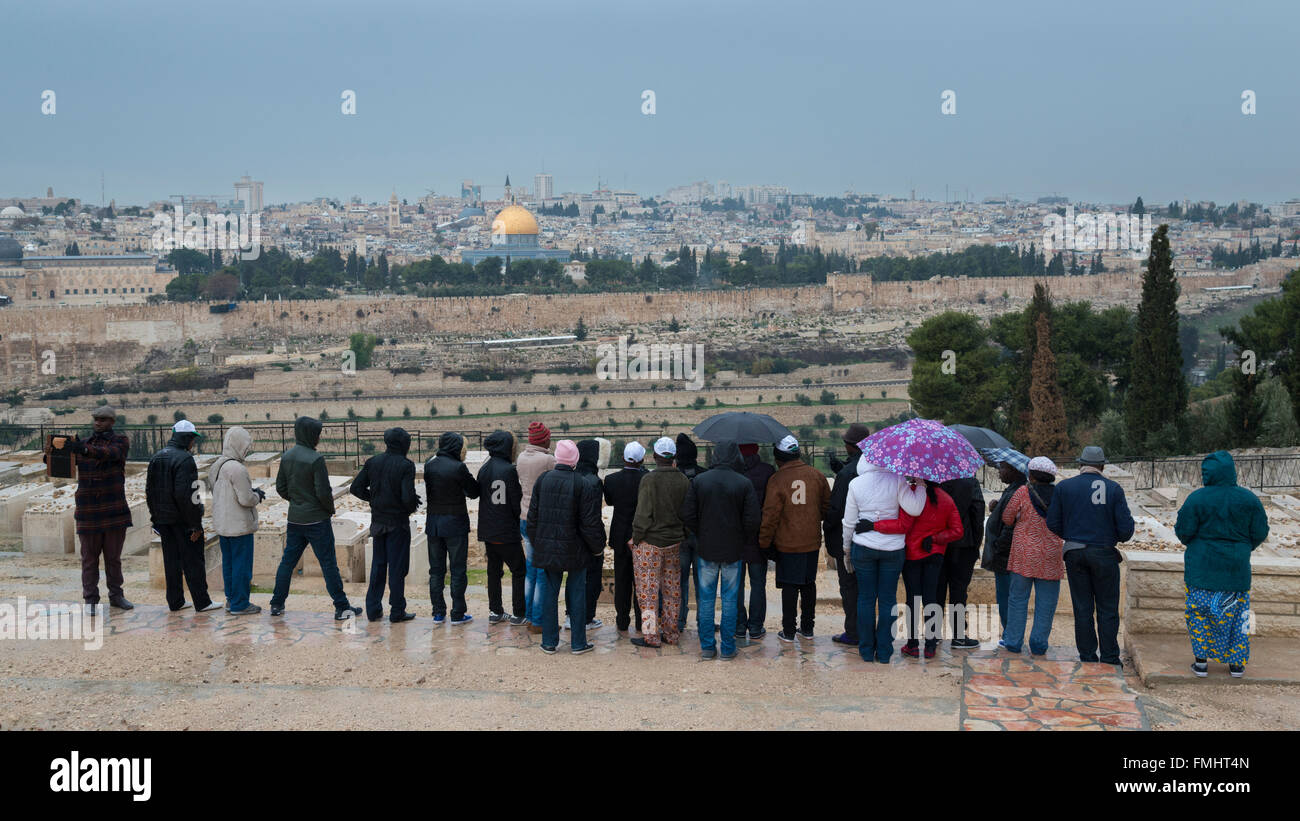 Group of pigrims looking at the Old City from the Mount of Olives. Jerusalem. Israel Stock Photo