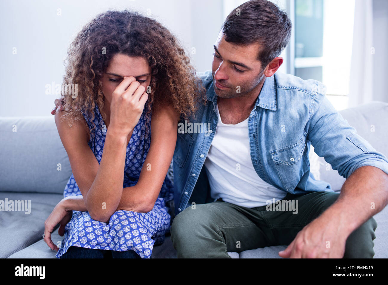 Young couple sitting together and discussing after a fight Stock Photo ...