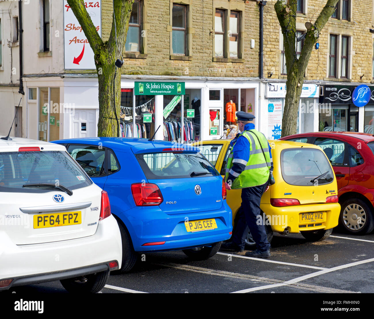 Traffic warden in car park, England UK Stock Photo