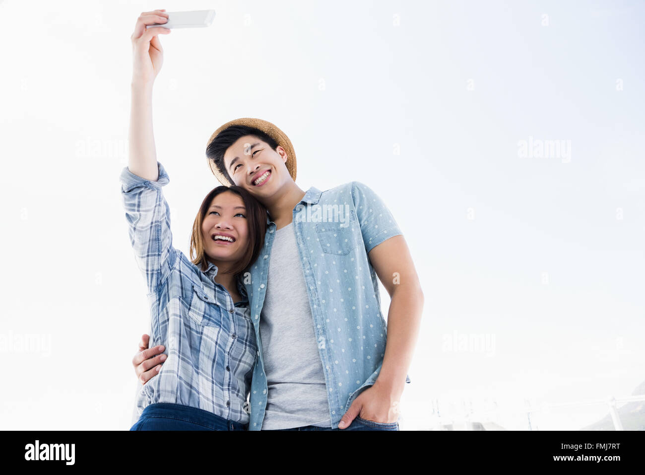 Happy young couple taking a selfie Stock Photo - Alamy