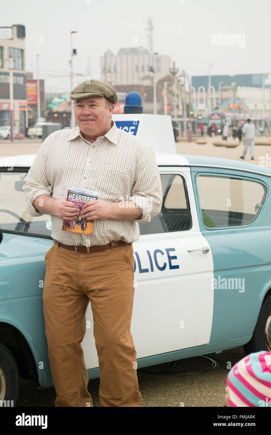 Blackpool,UK, 12th March 2016. Entertainment news. Actor David Lonsdale who plays the 'village fool' David Stockwell in the long running police series 'Heartbeat' promotes the new theatre tour based on the progamme at Blackpool's comedy carpet today. Posing for photograph's with the original police car from the show David speaks to members of the public to highlight this new theatre tour which starts at Blackpool's Grand Theatre on Wednesday the 16th of March. 2016. The nationwide tour finishes at Wolverhampton in July of this year Credit: Gary Telford/Alamy live news Stock Photo