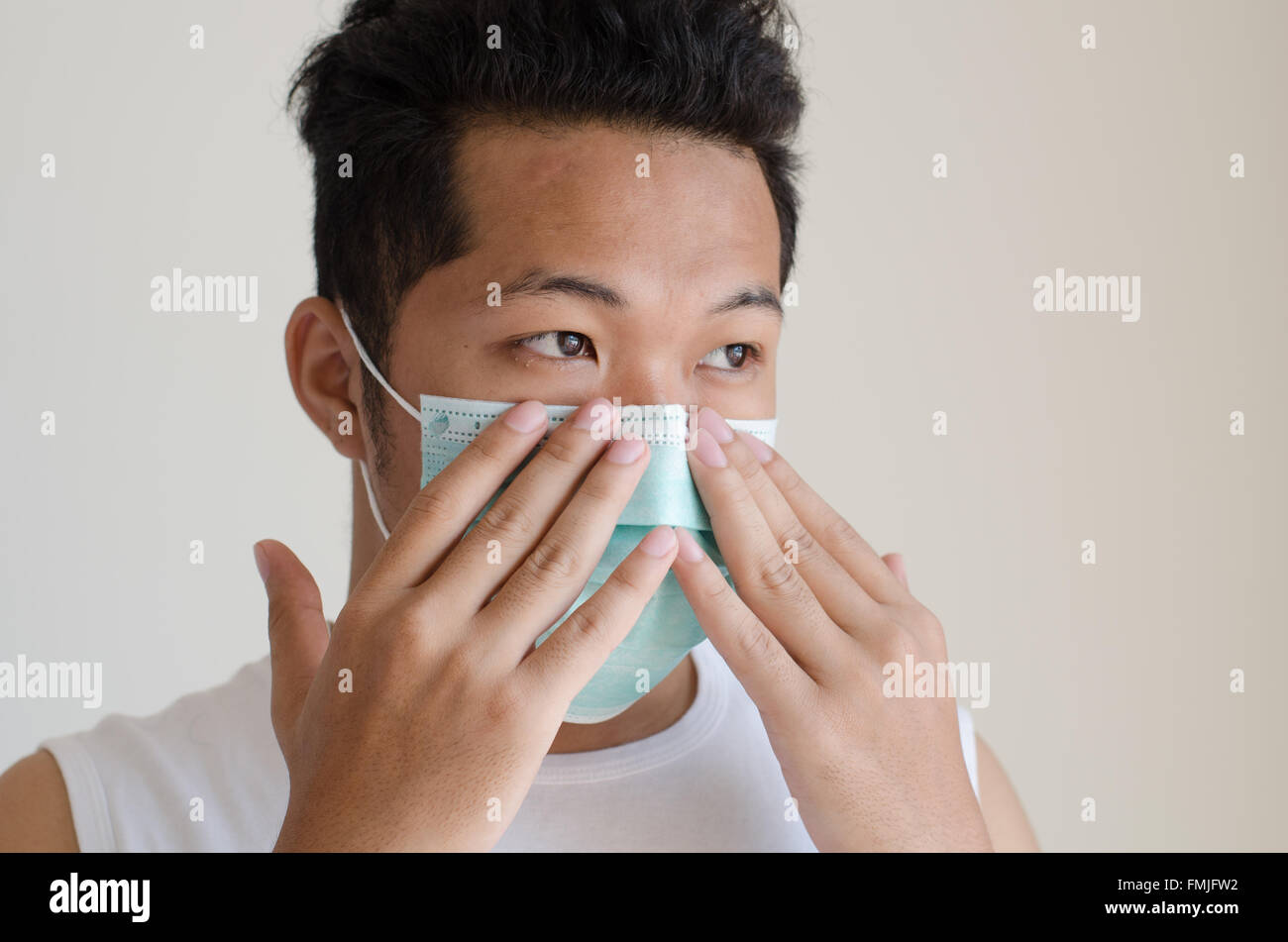 Asian man wearing a face mask Stock Photo