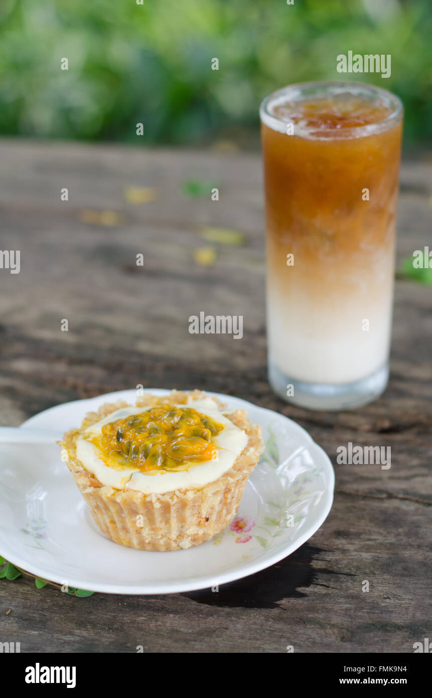 Passion fruit cheesecake and ice coffee Stock Photo