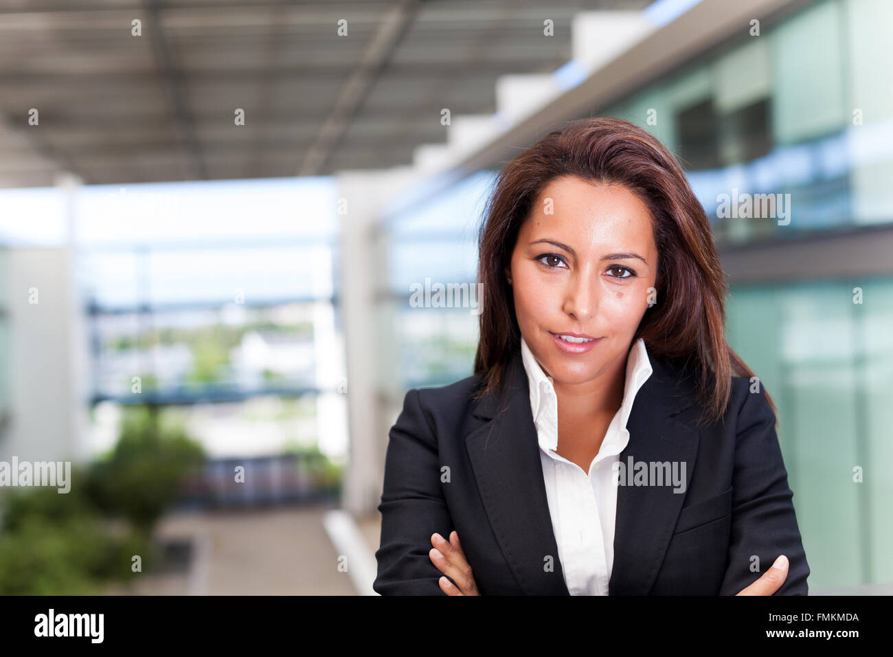 Smiling young business woman at the office Stock Photo - Alamy