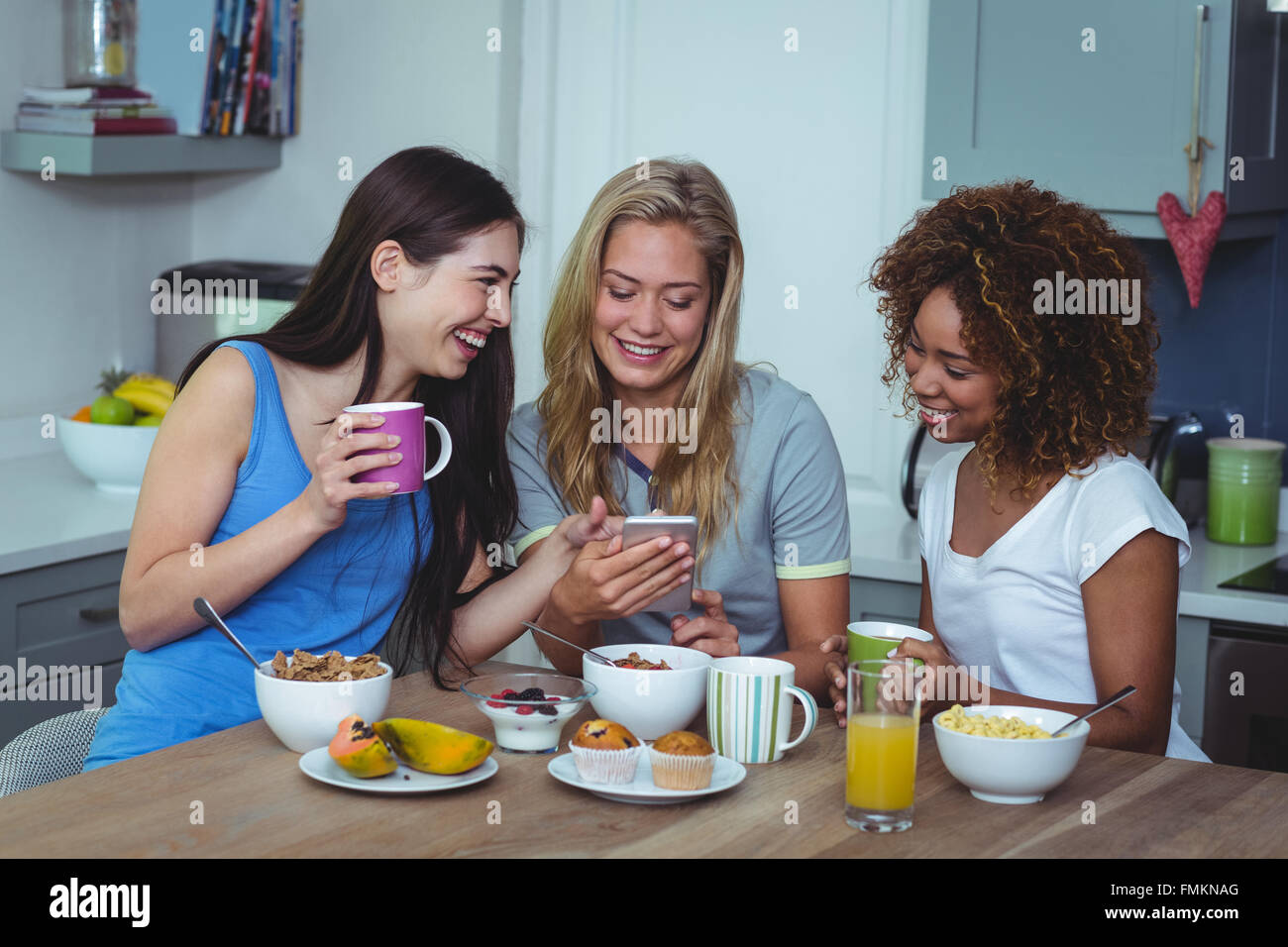 Am Using Friend Happy female friends using smartphone Stock Photo - Alamy