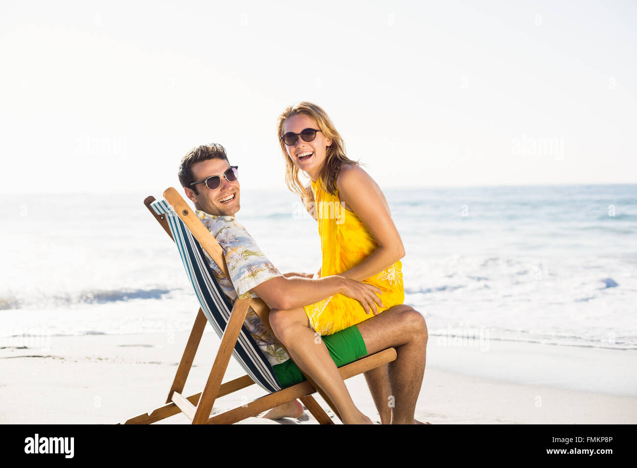 Woman Sitting On Mans Lap At Beach Stock Photo Alamy