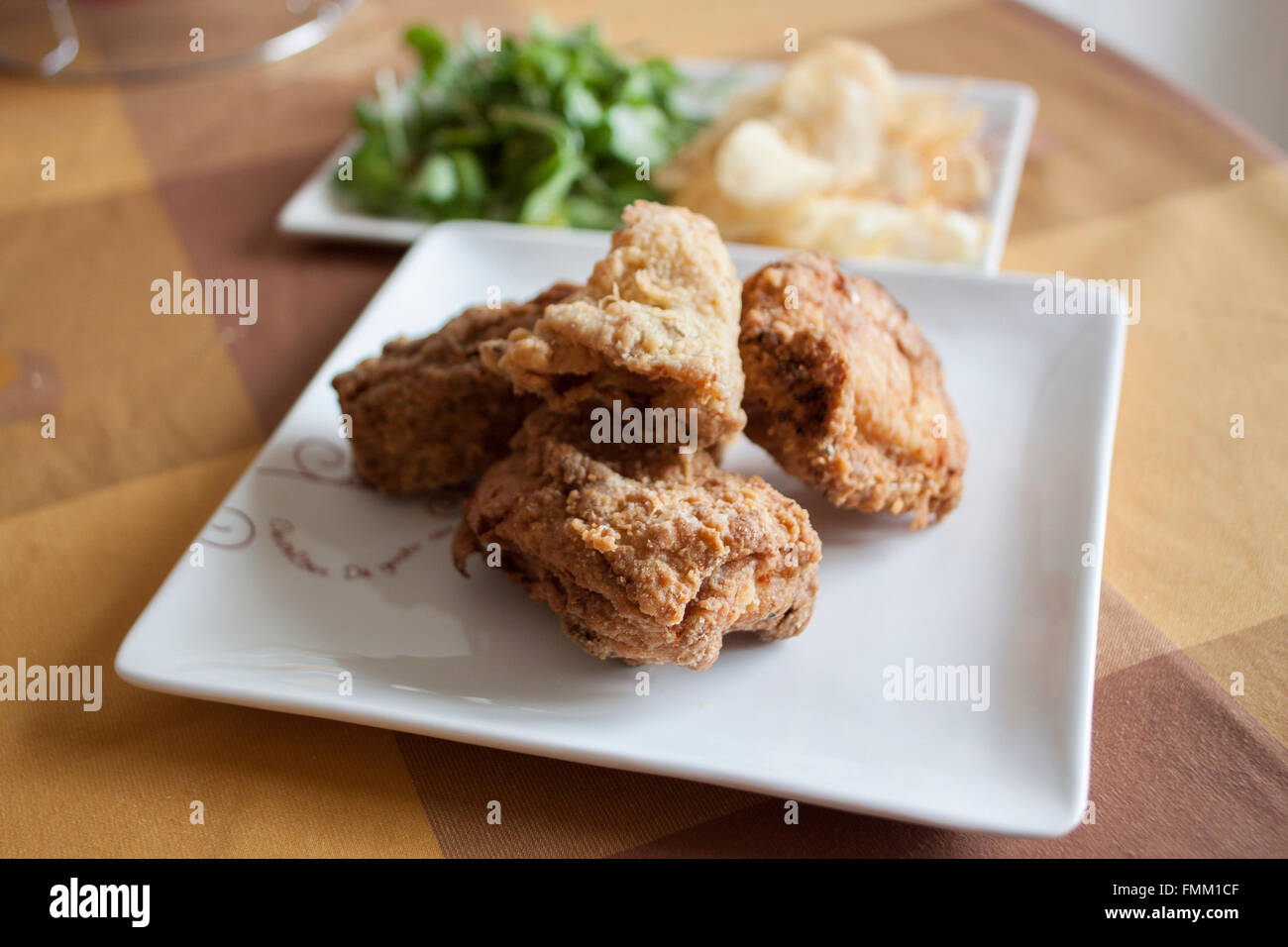 Fried chicken with potatoes and watercress Stock Photo
