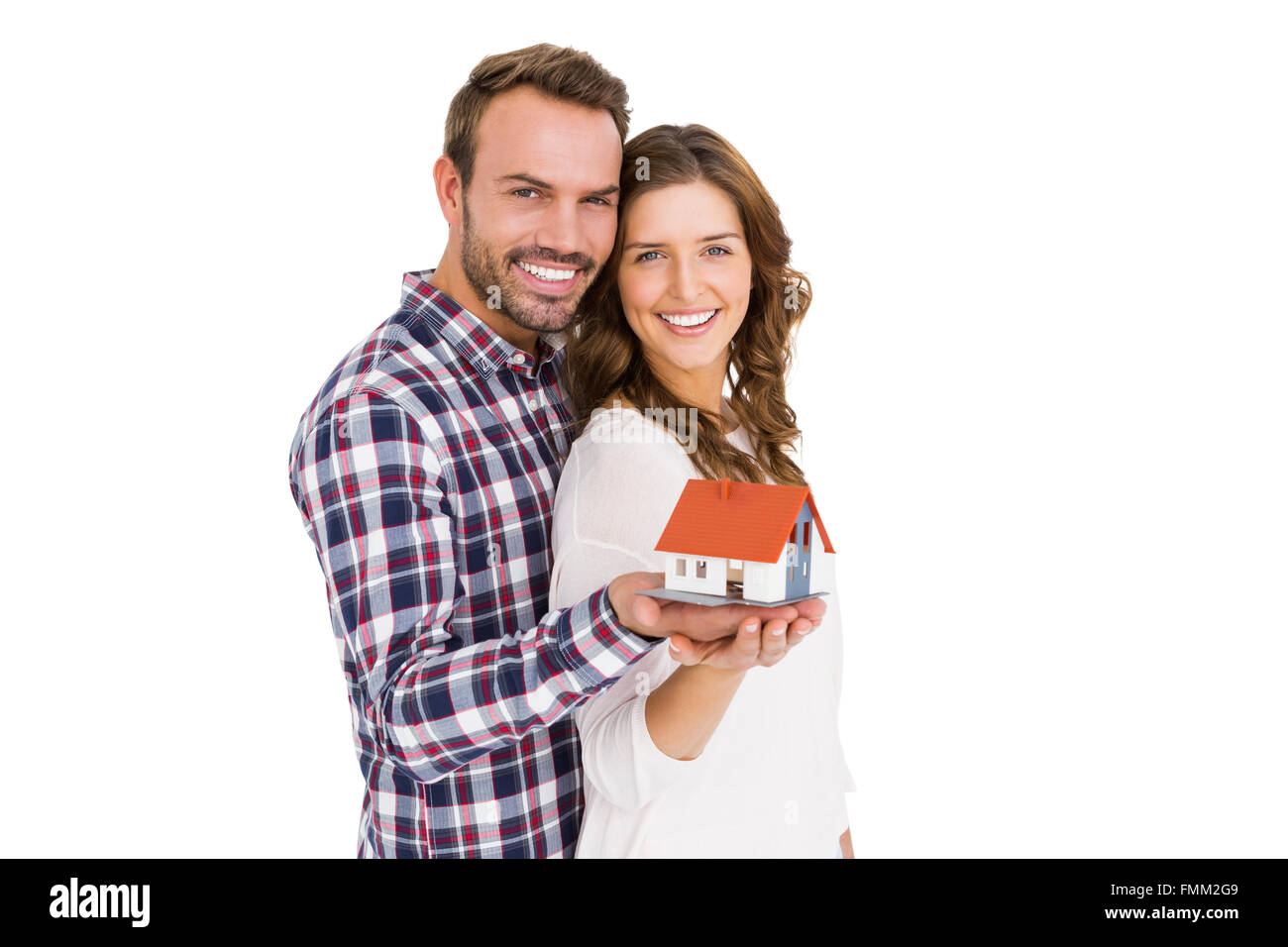Happy young couple holding model house Stock Photo - Alamy