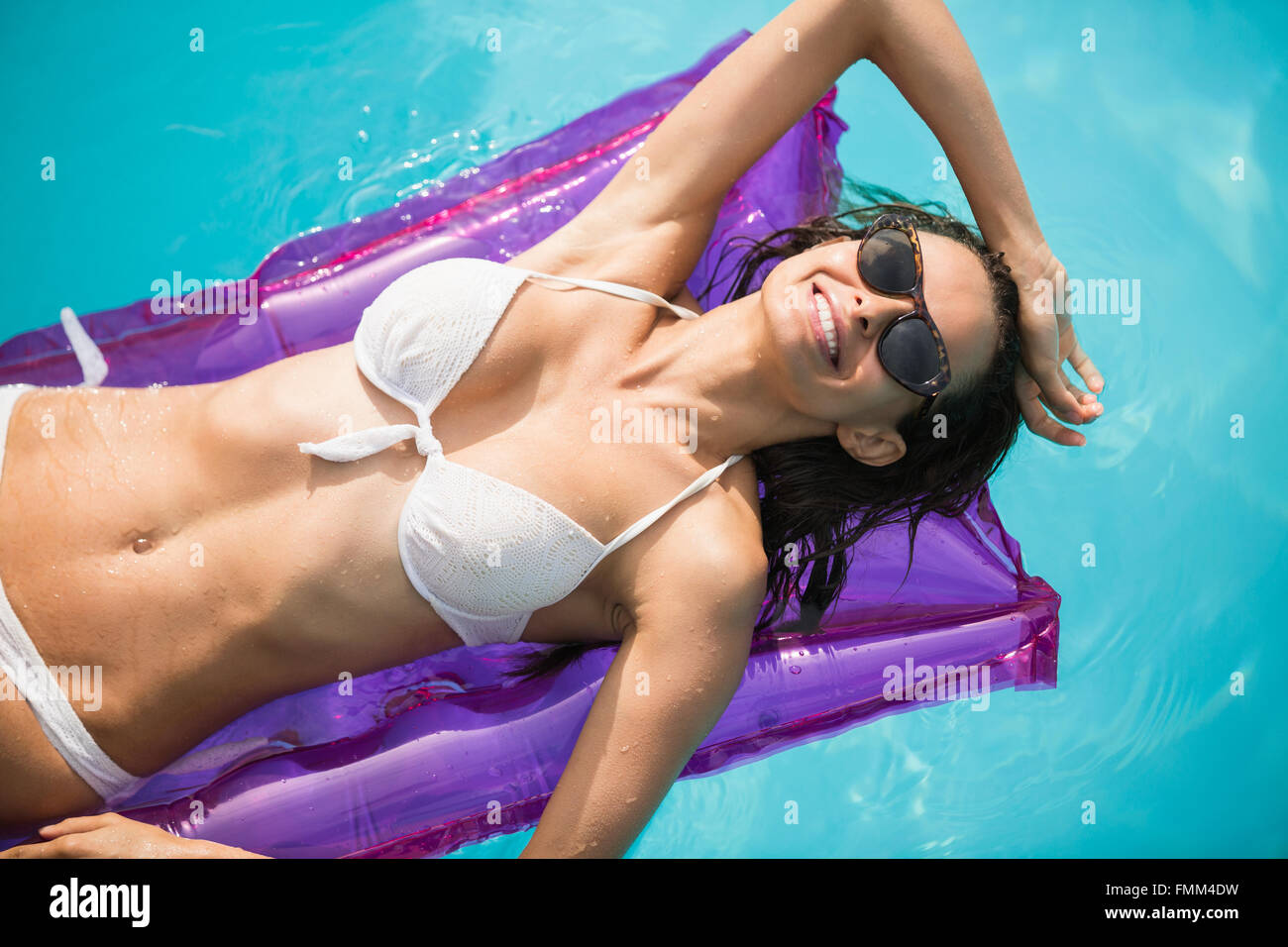 Young woman relaxing on inflatable raft Stock Photo