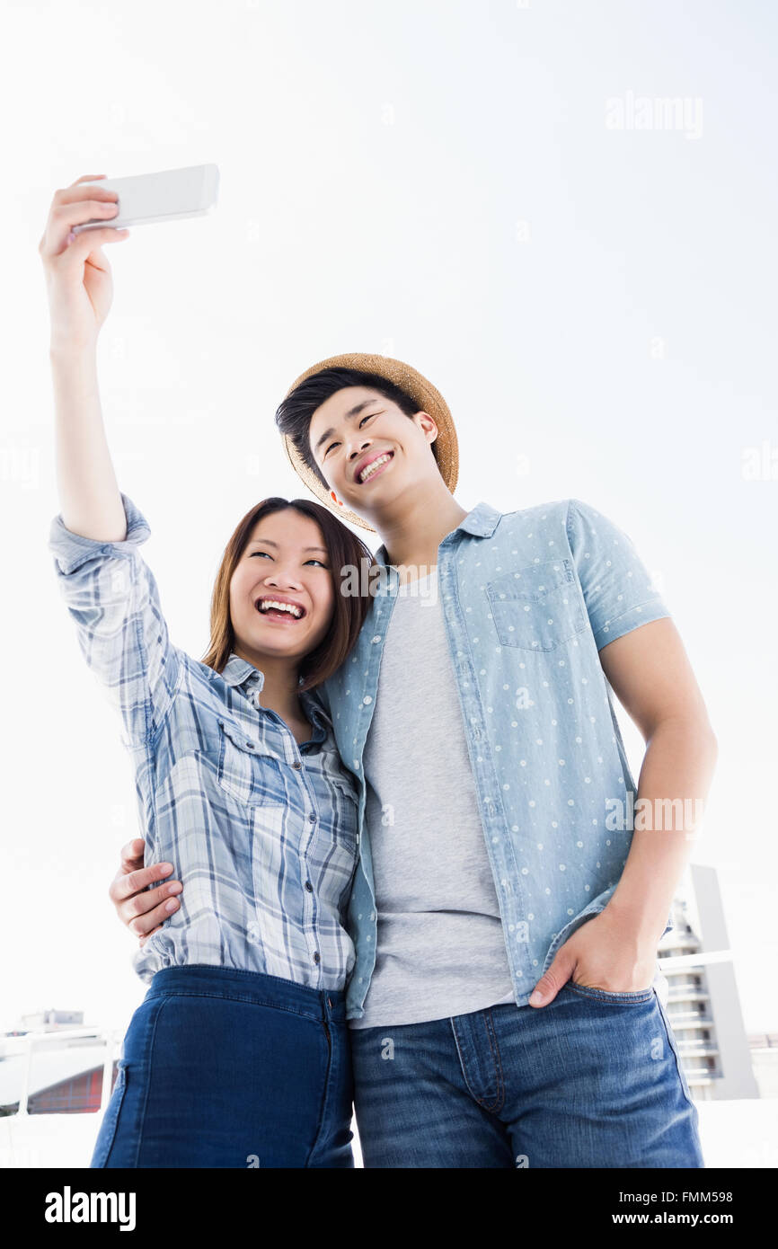 Happy young couple taking a selfie Stock Photo - Alamy