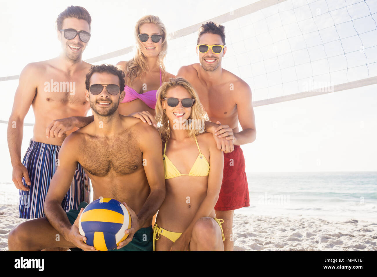 Smiling friends after playing volleyball Stock Photo