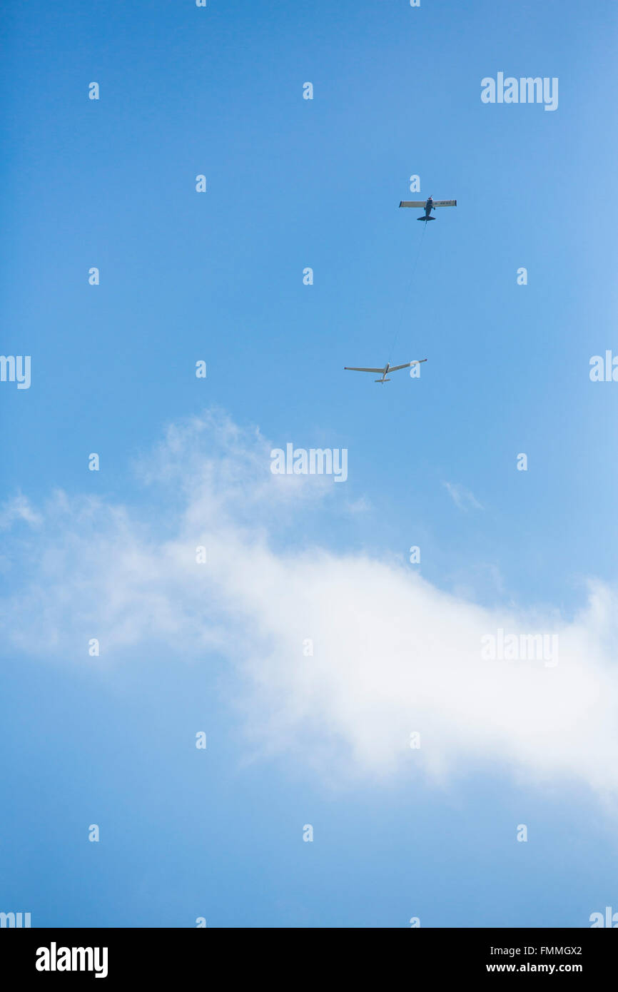 A glider being towed bya  light aircraft as part of it's launching procedure. Stock Photo