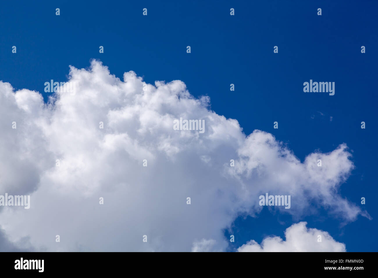 White fluffy clouds in blue sky Stock Photo - Alamy