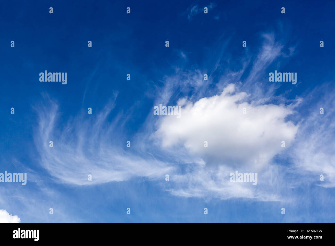 White fluffy and wispy clouds in blue sky Stock Photo - Alamy