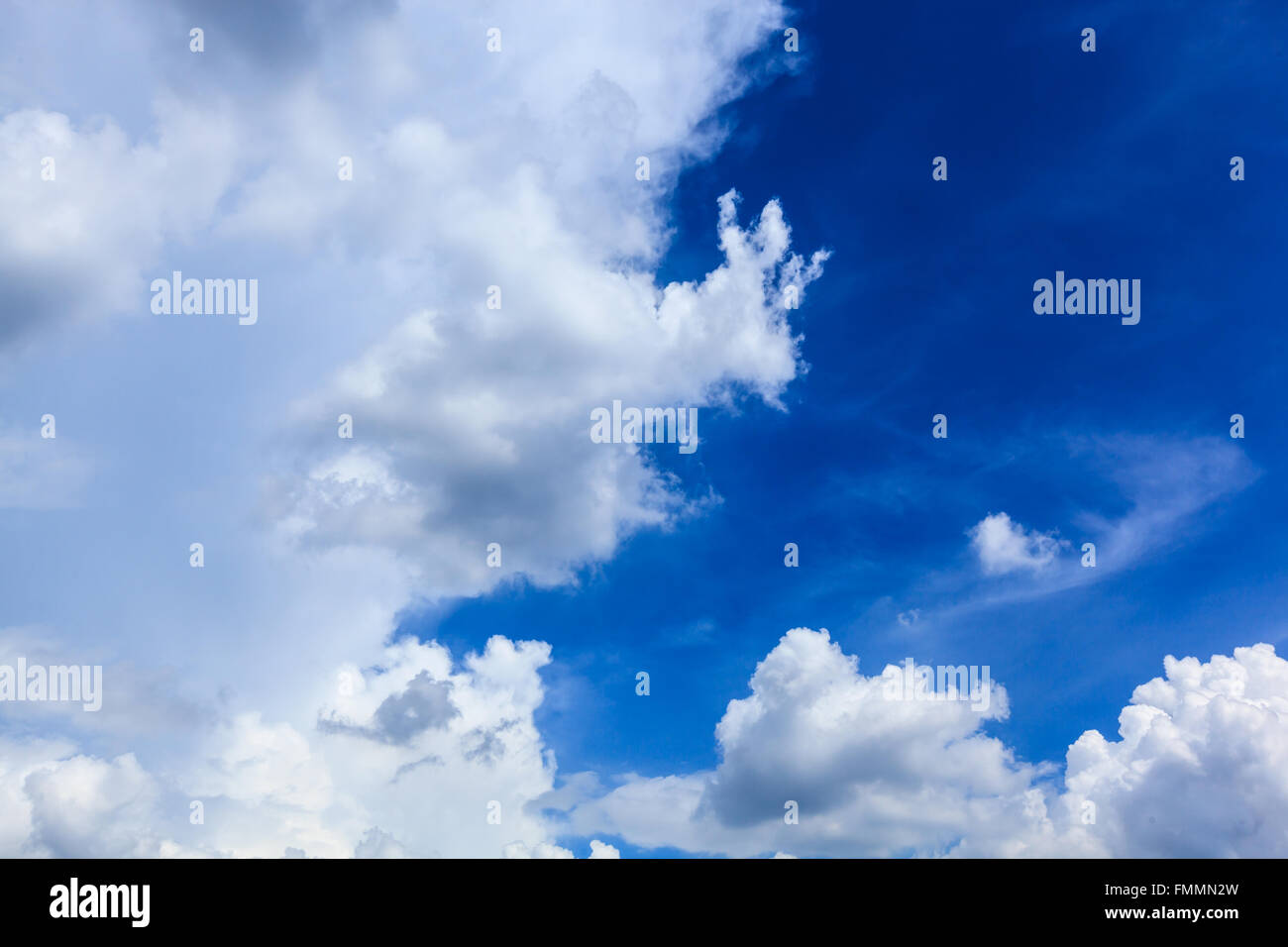 White fluffy clouds in blue sky Stock Photo - Alamy
