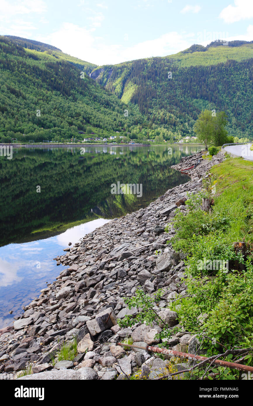 Summer Norway landscape with shore of fjord and mountain forest Stock Photo