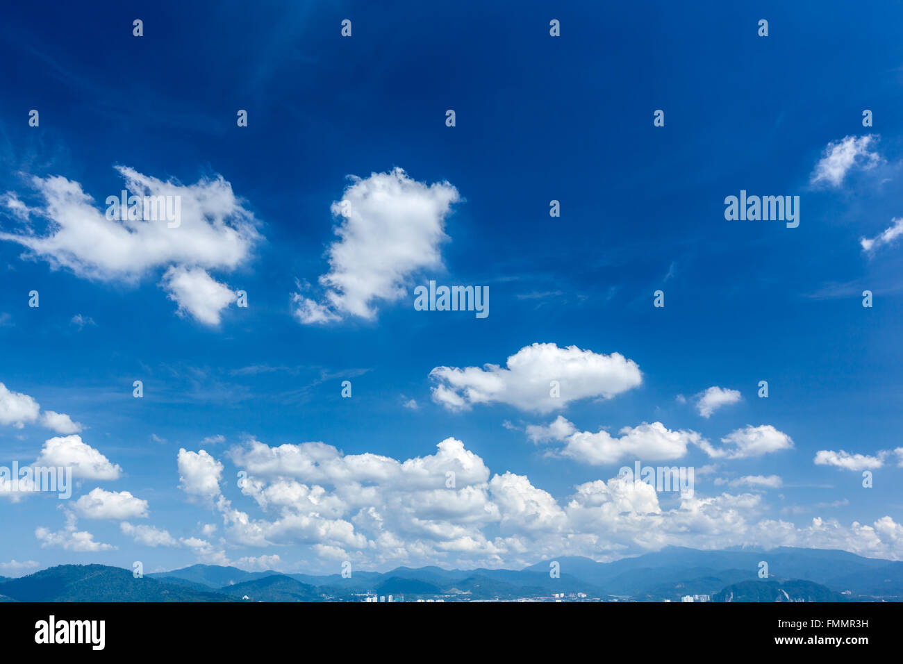 White fluffy clouds in blue sky Stock Photo - Alamy