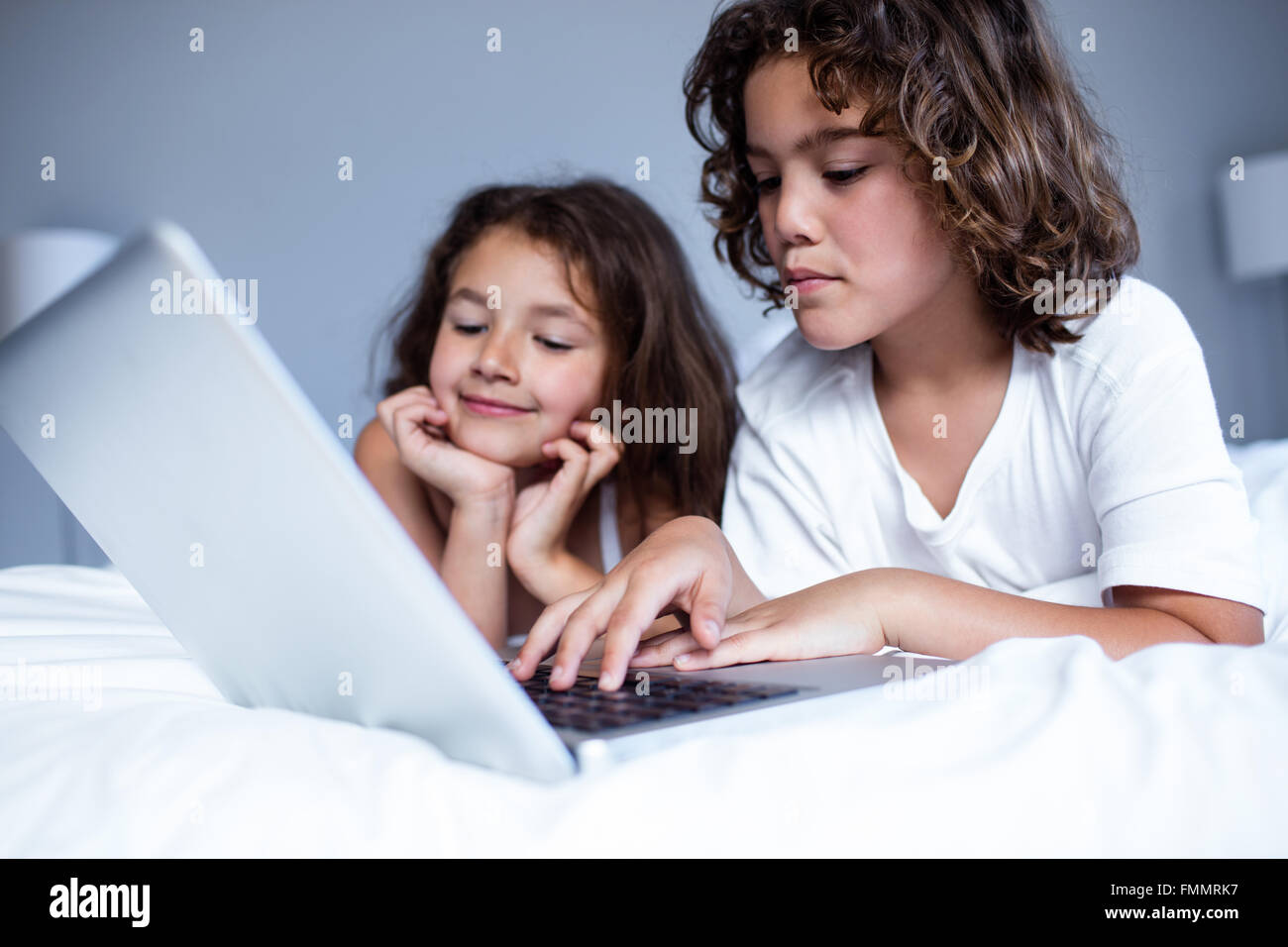 Brother and sister using digital tablet Stock Photo - Alamy