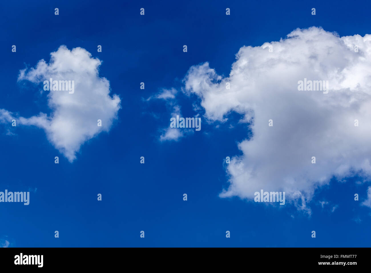 Isolated white fluffy clouds in blue sky Stock Photo