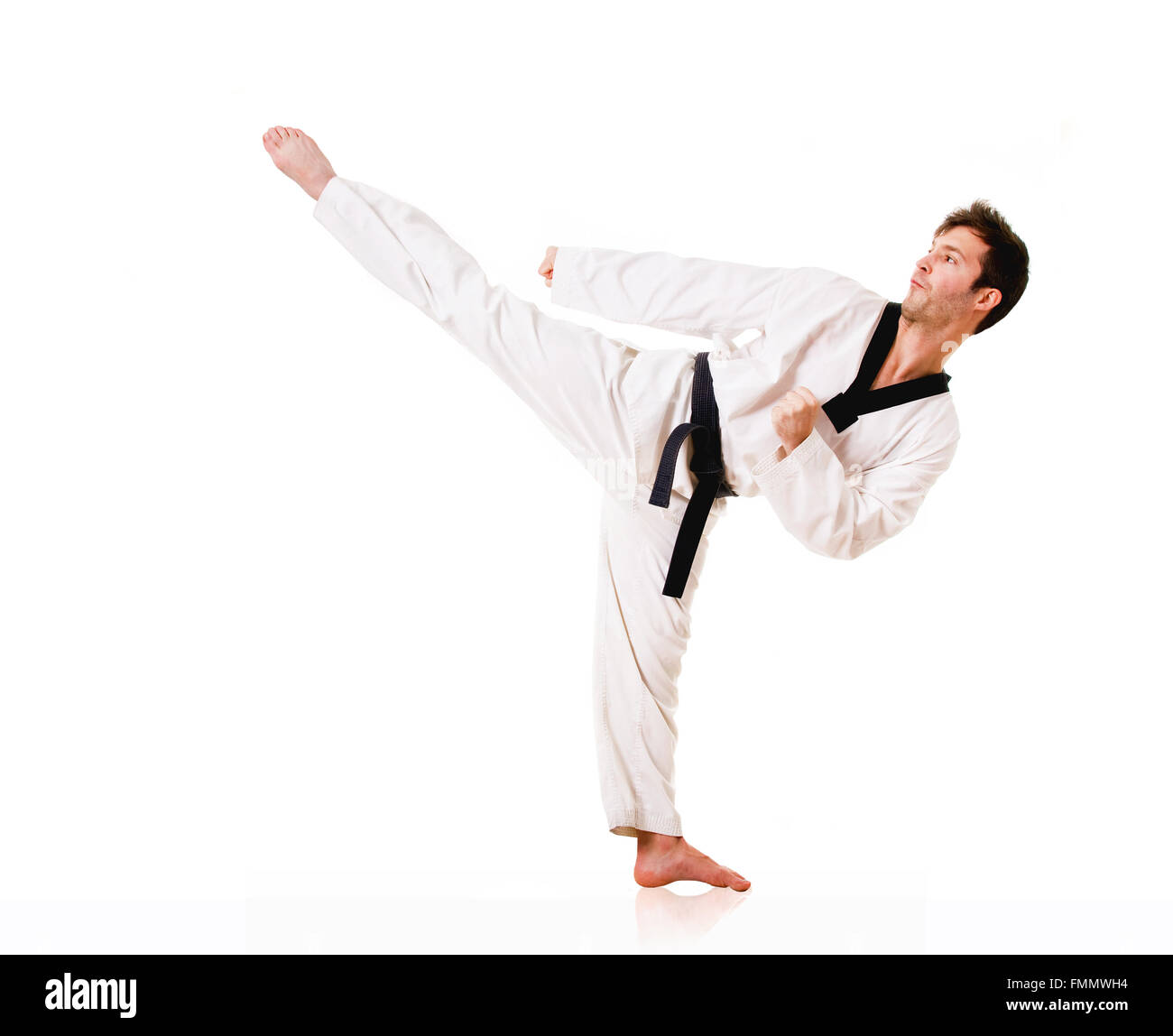 Young man practicing martial arts over white background Stock Photo Alamy
