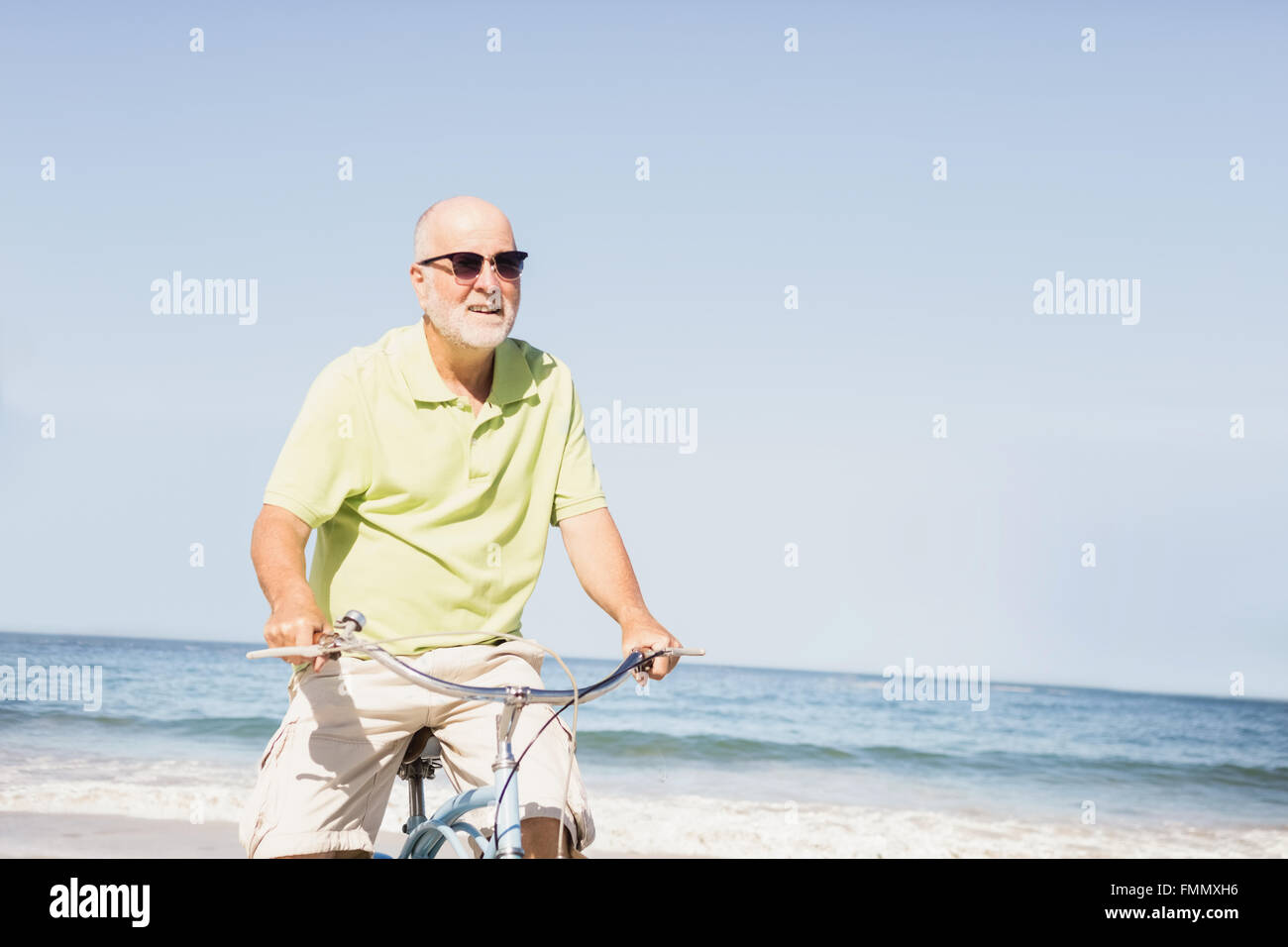 Smiling senior man riding bike Stock Photo - Alamy
