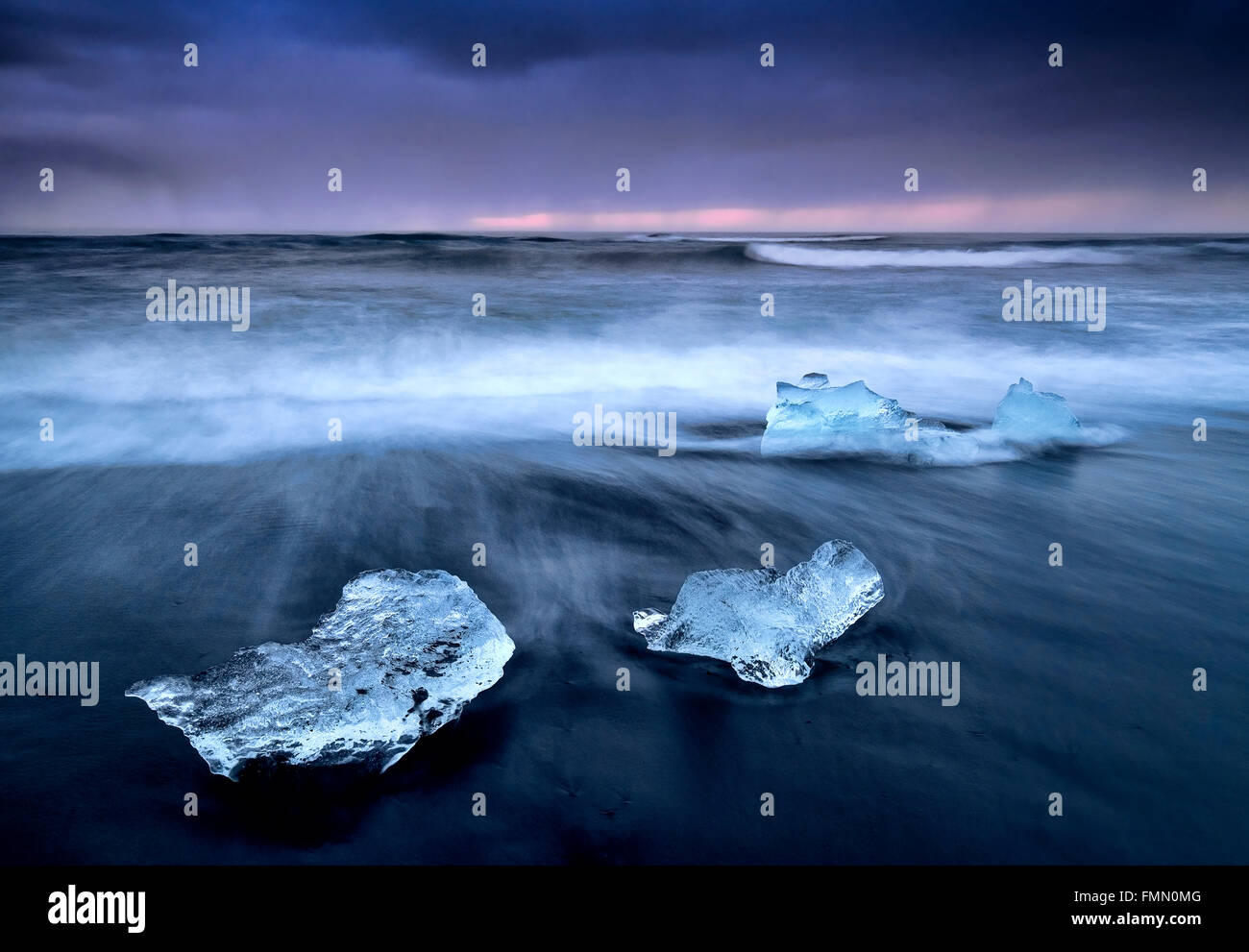 Icebergs on Fellsfjara Volcanic Beach at Twilight, near Jokulsarlon, Southern Iceland Stock Photo