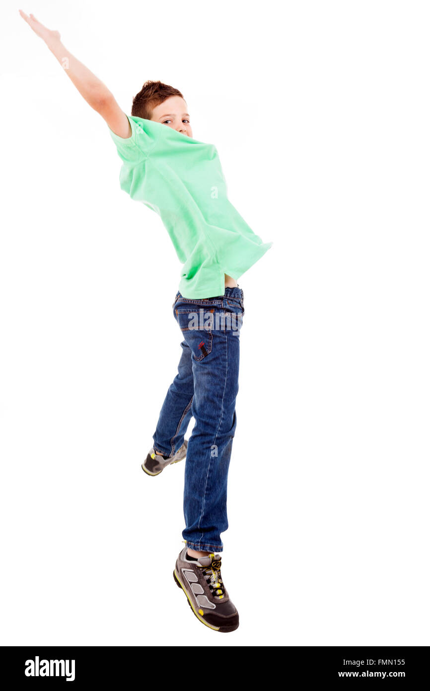 Portrait of happy little boy jumping with outstretched arms isolated on white background Stock Photo