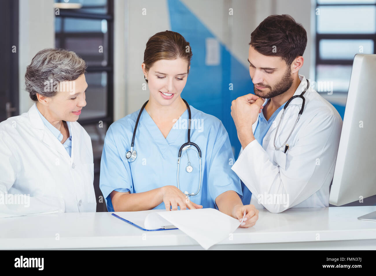 Doctor team working at computer desk Stock Photo - Alamy