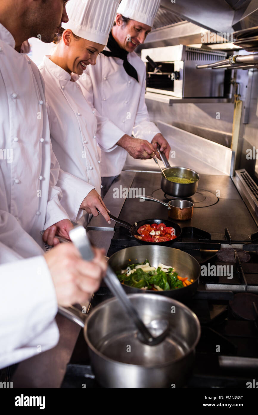 Group of chef preparing food in the kitchen Stock Photo Alamy