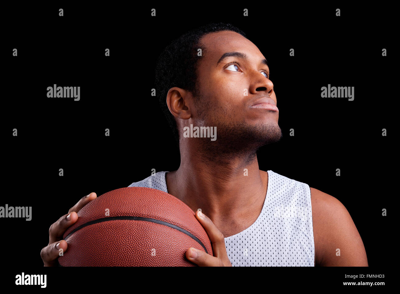 Basketball player with ball against dark background Stock Photo
