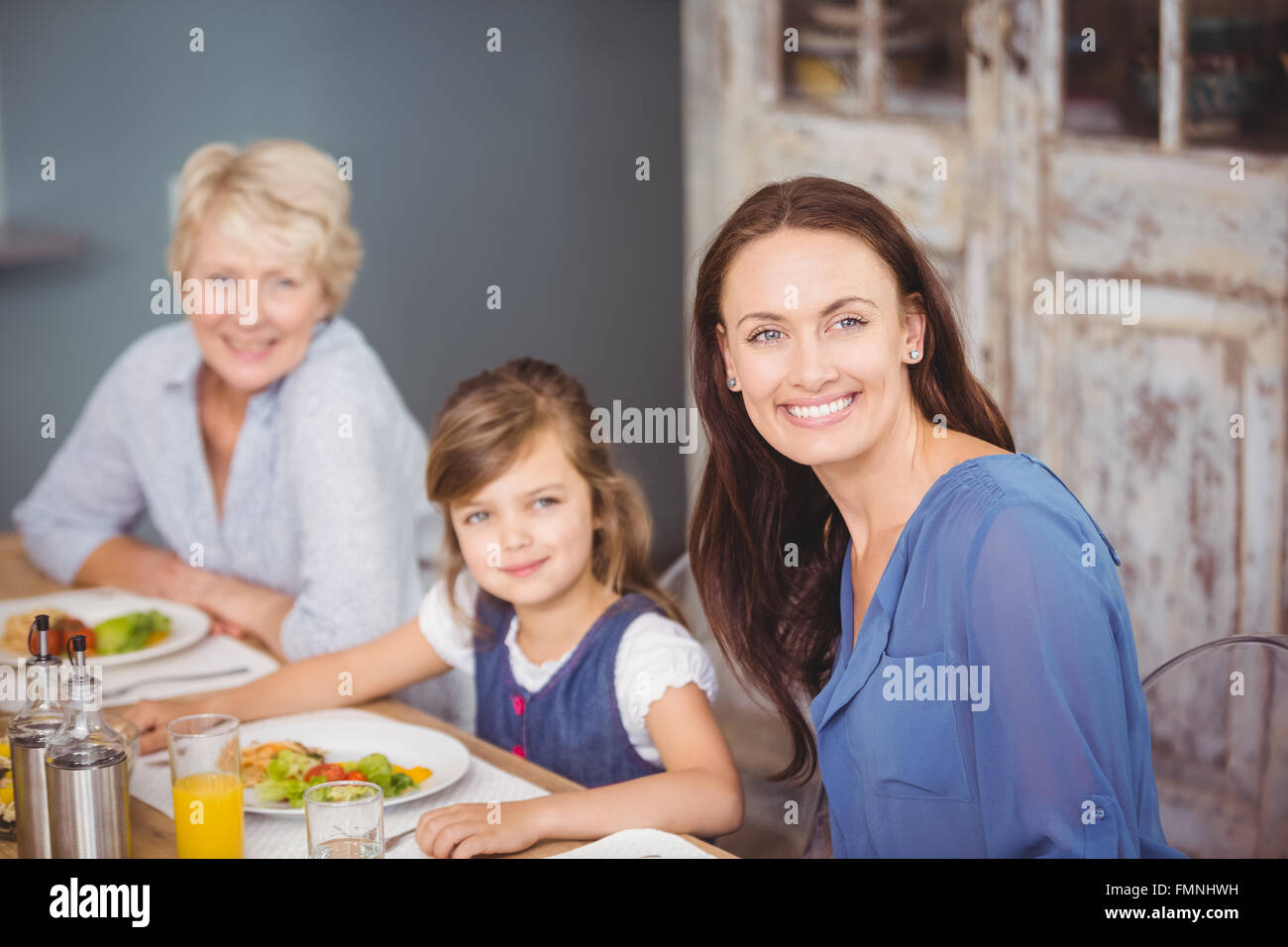Portrait of happy family having breakfast Stock Photo - Alamy