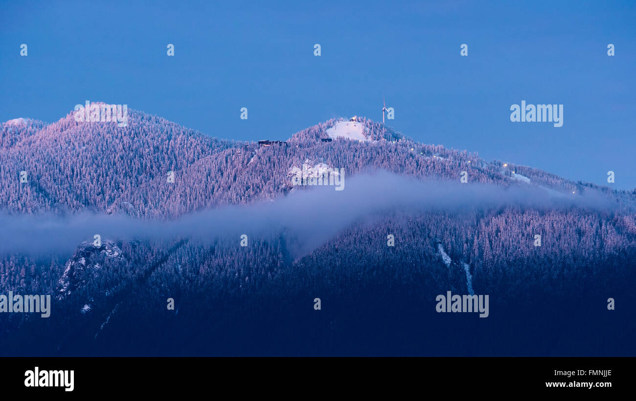 Scenic winter wintry snowy snow capped view Grouse Mountain North Shore Mountains Vancouver Canada Stock Photo