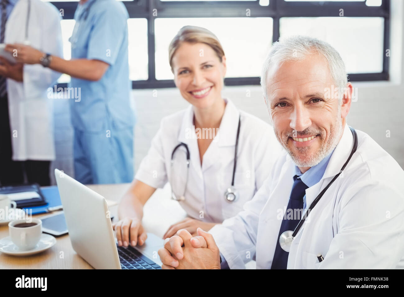 Portrait of two doctors smiling in conference room Stock Photo Alamy