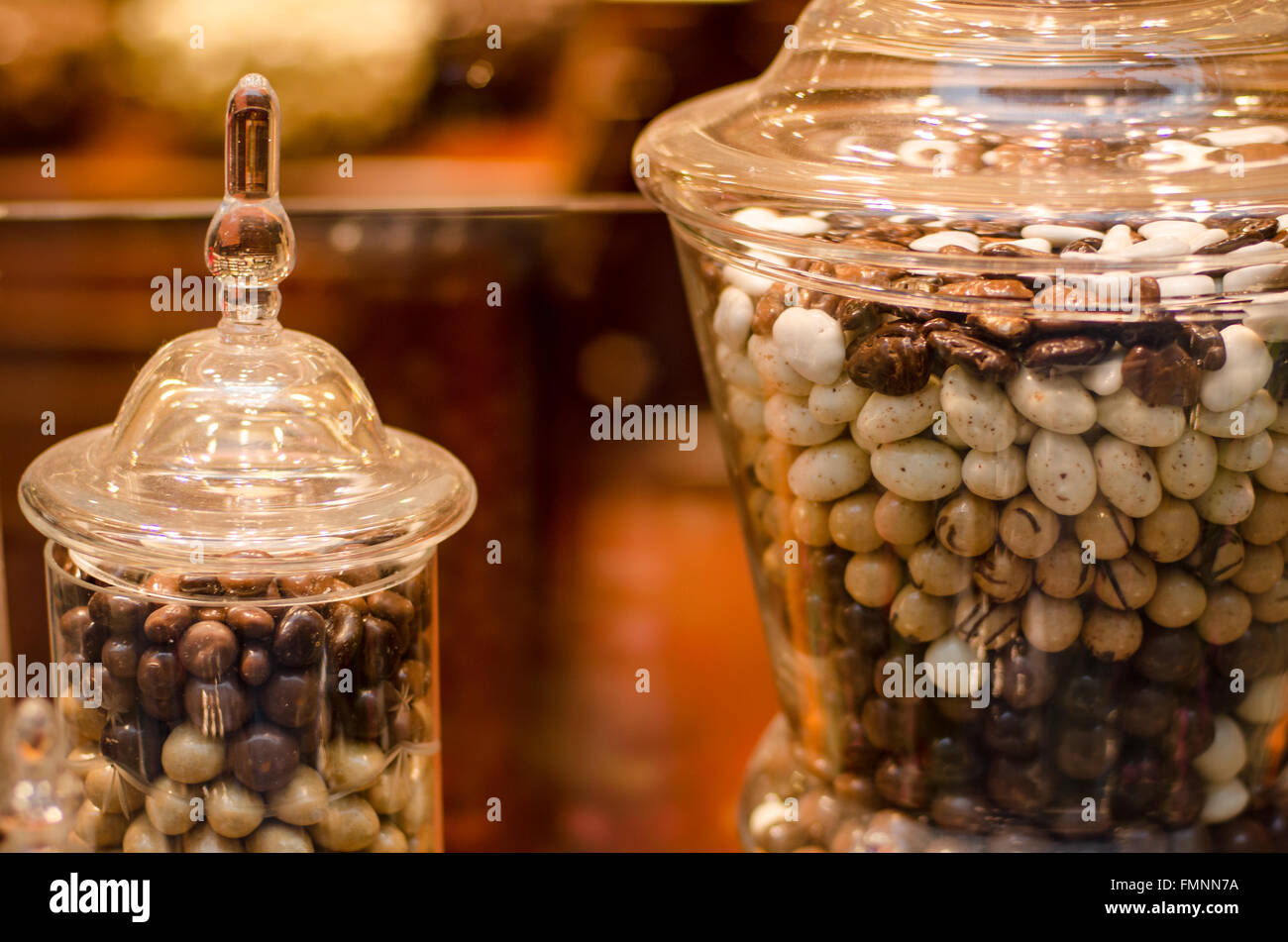 Details close-up of delicious traditional chocolate Belgian pralines in the glass jar. Stock Photo
