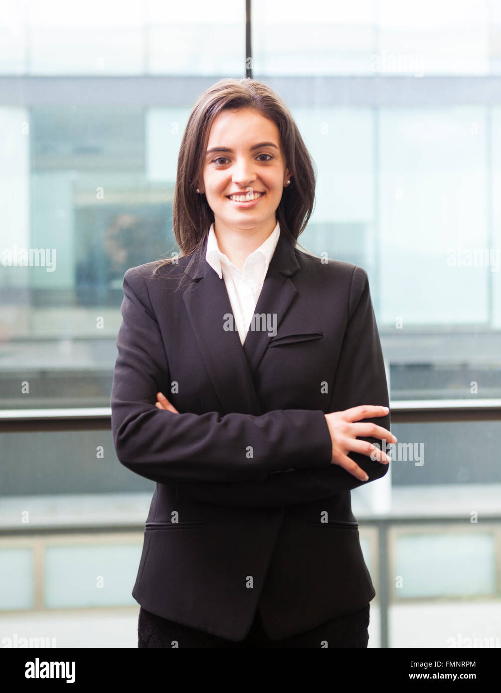 Portrait of a happy smiling young business woman with cross-armed Stock Photo