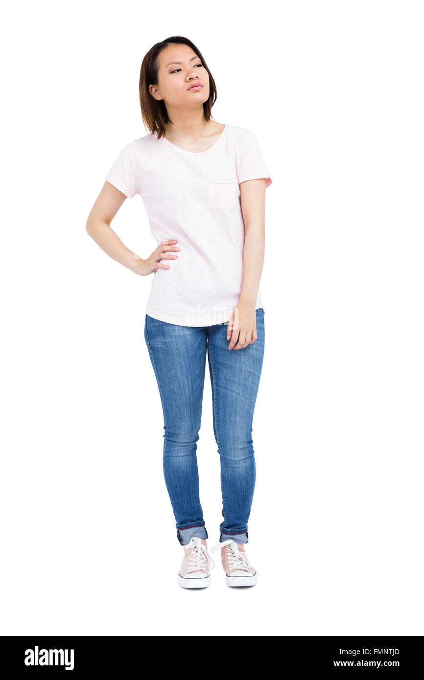 Thoughtful young woman standing with hands on hip Stock Photo - Alamy