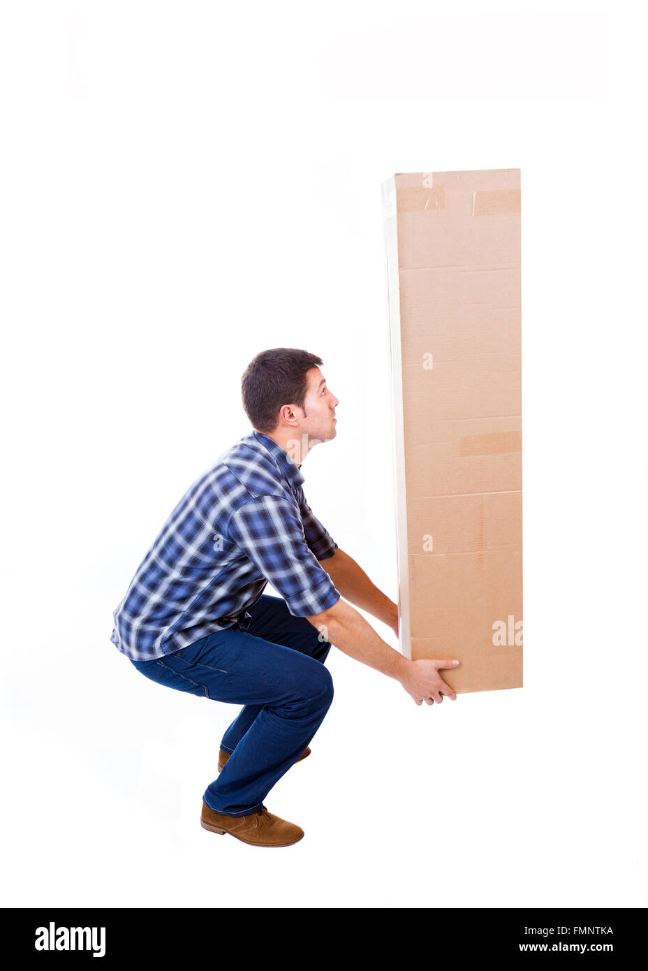 Young man lifting a cardboard box, isolated on white background Stock Photo