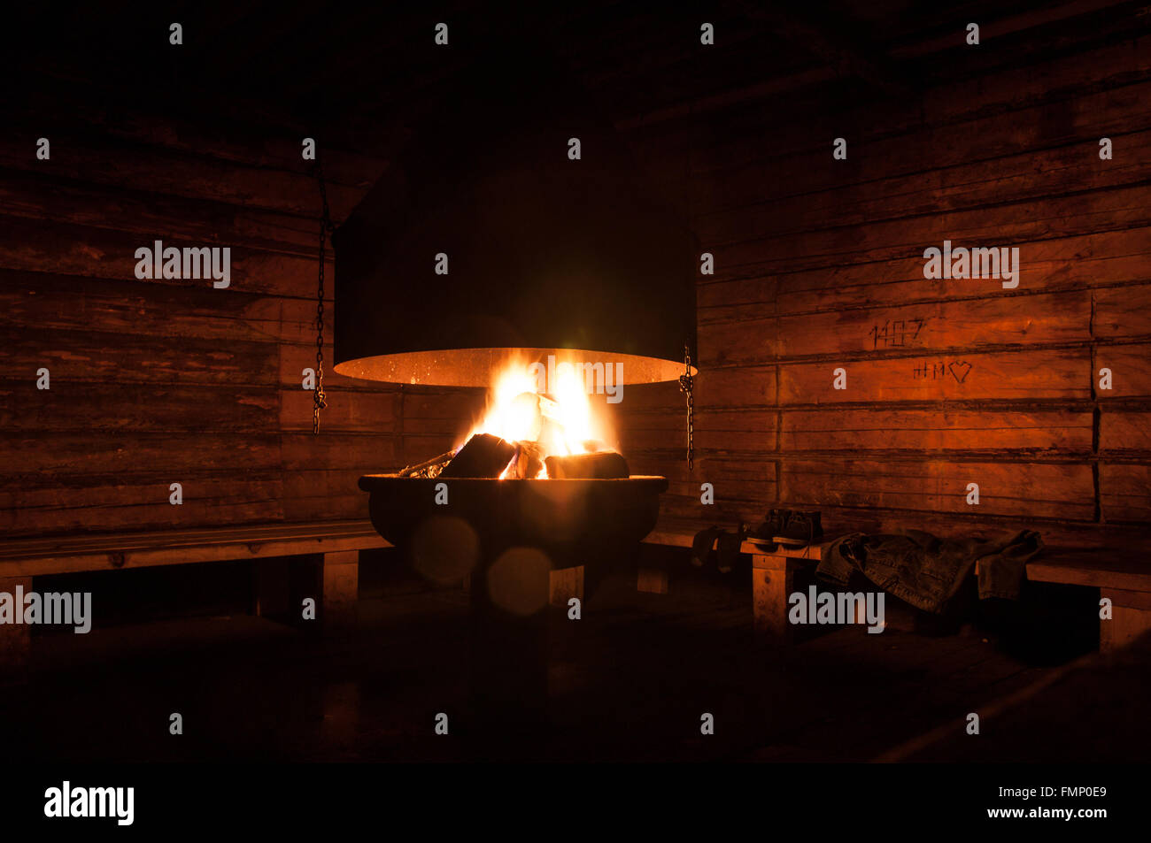 camp fire place inside the wooden cottage Stock Photo